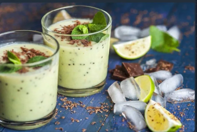 zwei Gläser eines cremigen, hellgrünen Getränks, garniert mit Schokoladenraspeln und Minzblättern, wahrscheinlich ein Smoothie oder Milchshake. von Hoppes Ernährungs&Fitness Beratung GbR